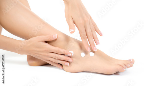 Woman apply the ointment on legs. Depilation or another woman legs healths concept © Glebstock
