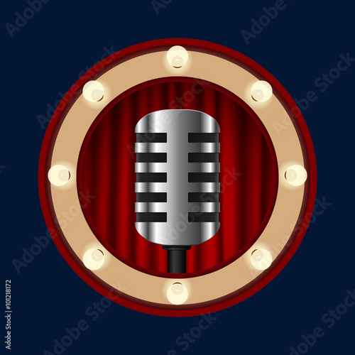 retro microphone on a background of red curtains in a circle of light bulbs