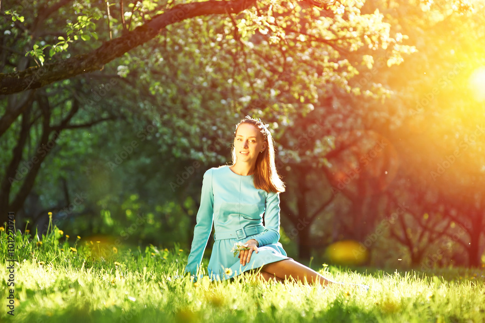 Woman in dress among apple blossoms