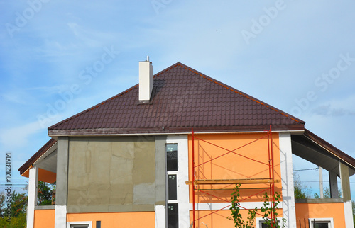 Murais de parede Construction or repair house with balcony, eaves, windows, chimney, metal tile r