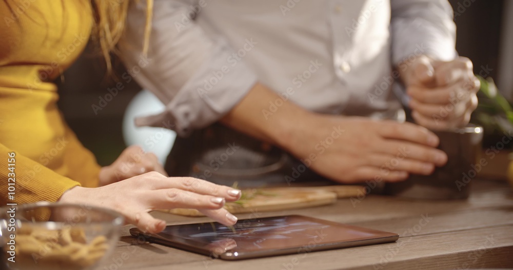Couple prepare together dinner at home in the evening close-up in slow motion (in realtime at 60 fps) Couple prepare together dinner at home in the evening close-up in slow motion (in realtime at 60 fps)