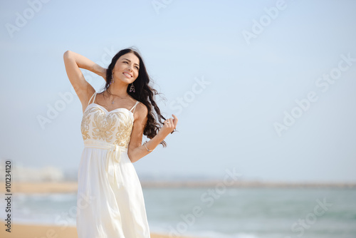 Beautiful sexy elegant female on the beach background