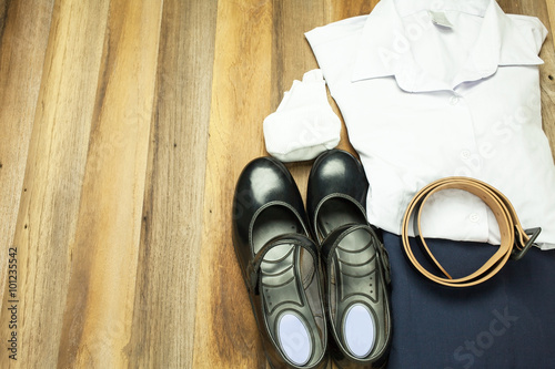 Still life : Thai Student girl uniform with wooden background on top view