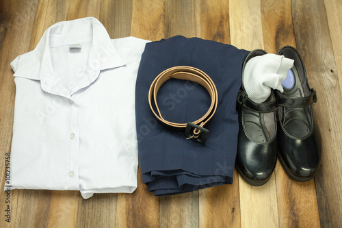 Still life : Thai Student girl uniform with wooden background on top view