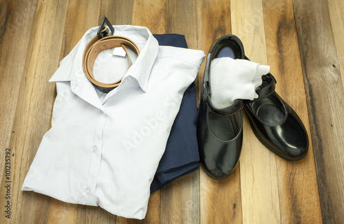 Still life : Thai Student girl uniform with wooden background on top view
