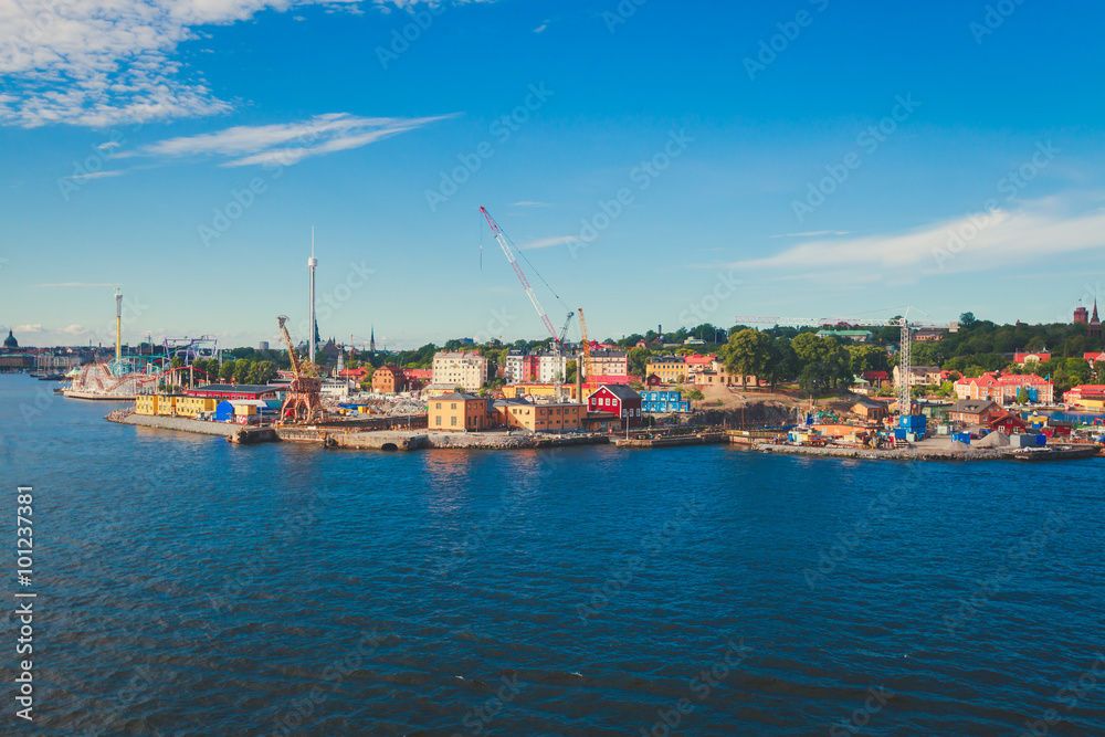 Beautiful super wide-angle panoramic aerial view of Stockholm, Sweden with harbor and skyline with scenery beyond the city, seen from the observation tower, sunny summer day with blue sky
