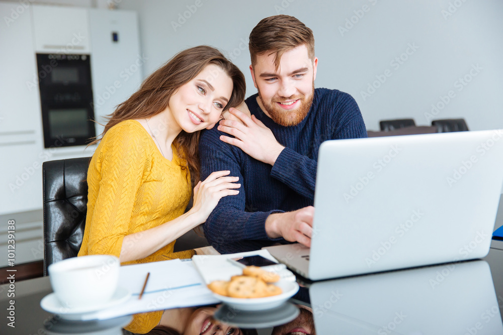 Couple using laptop computer at home Couple using laptop computer at home