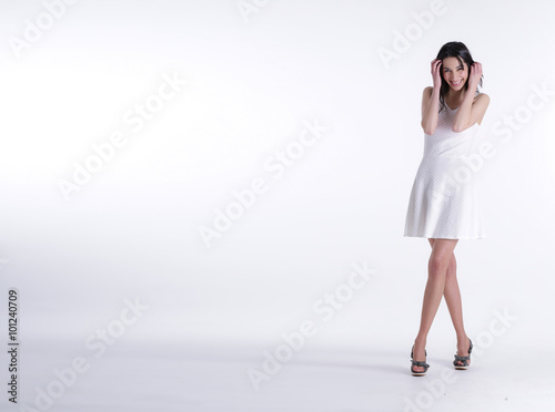 Girl with white dress smiling on white background