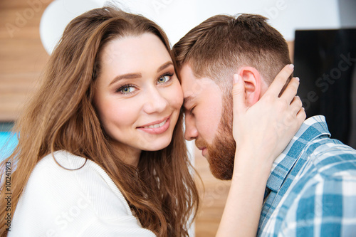 Happy woman and bearded man hugging gently © Drobot Dean