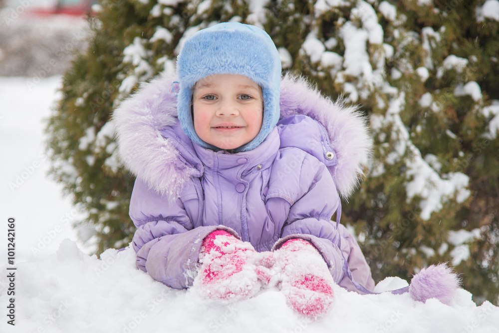 Girl lying in the snow and the snow smiling Girl lying in the snow and the snow smiling