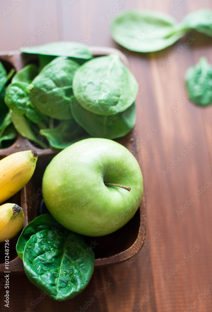 Fresh and organic green apple with spinach, bananas on rustic background. Healthy Still life Fresh and organic green apple with spinach, bananas on rustic background. Healthy Still life