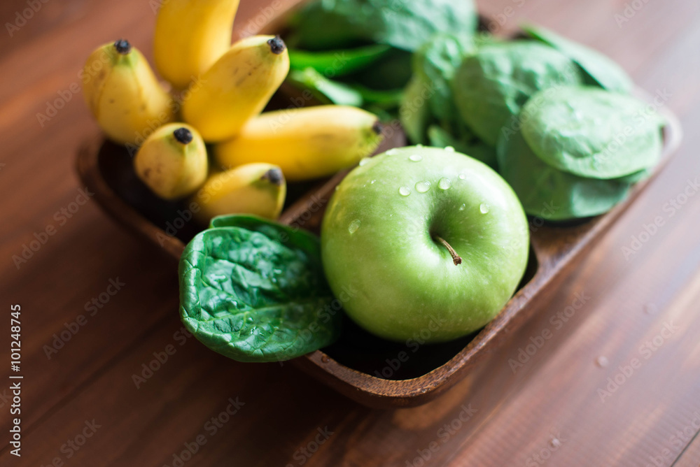 Fresh and organic green apple with spinach, bananas and pine nuts on rustic background. Healthy Still life 