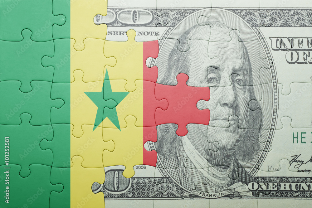 puzzle with the national flag of senegal and dollar banknote