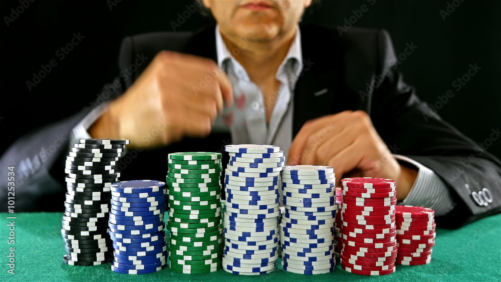 A poker gambler peeks at his cards and tosses them A poker gambler peeks at his cards and tosses them