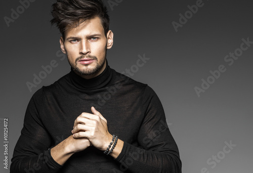 Portrait of young model with clenched hands