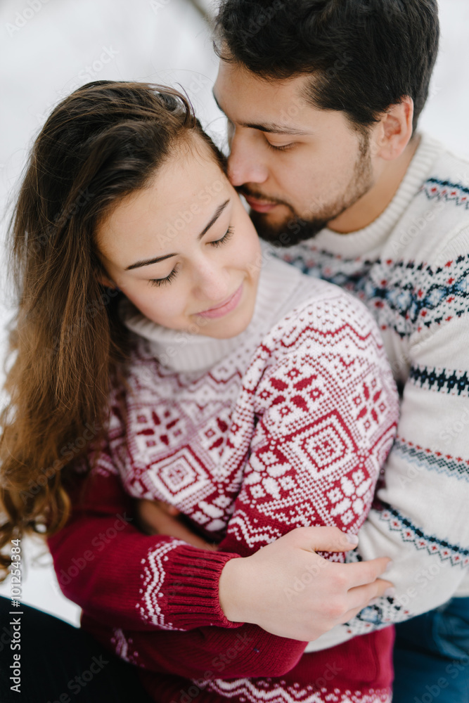 Cute young hipster couple having fun in winter park warming eachother on a bright day hugging each other and smiling
Cute young hipster couple having fun in winter park warming eachother on a bright day hugging each other and smiling