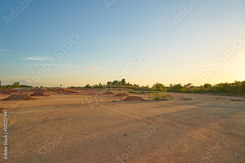 Tropical laterite soil or red earth background. Red mars seamless sand background.with blue sky. photo