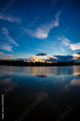 blue evening sky and smooth water surface