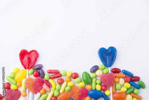 Border of colorful jelly candies on white