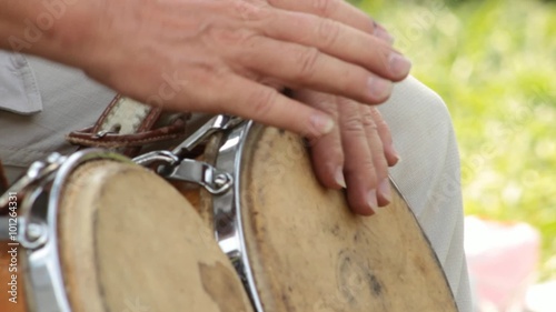 Man Banging Bongo Drums