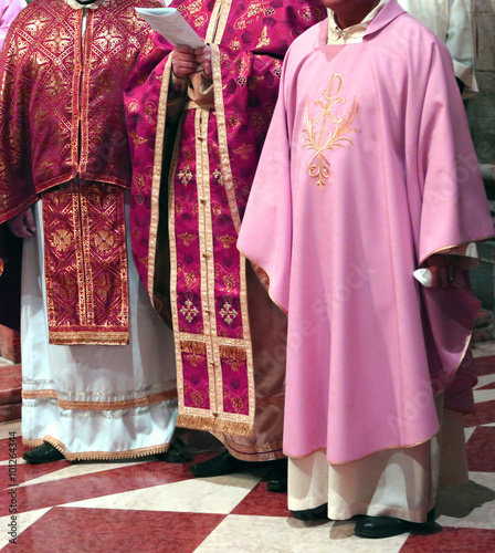 Photo priests with cassock in church during the Holy Mass
