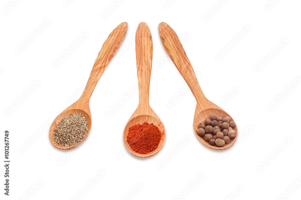 Different kinds of pepper in three wooden spoons Different kinds of pepper in three wooden spoons