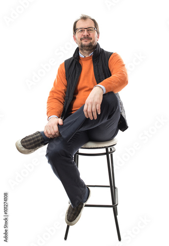 Confident male model with crossed legs.