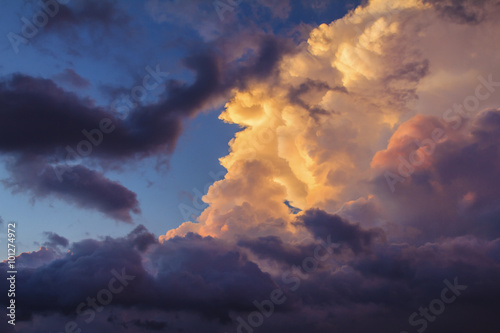 Beautiful summer sky with the clouds on sunset changing different colors. From blue to, yellow, orange, purple....