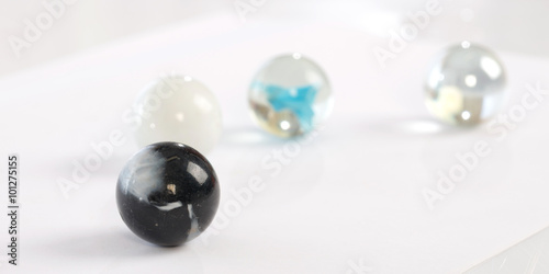 glass marbles balls on white blackground ,selective focus