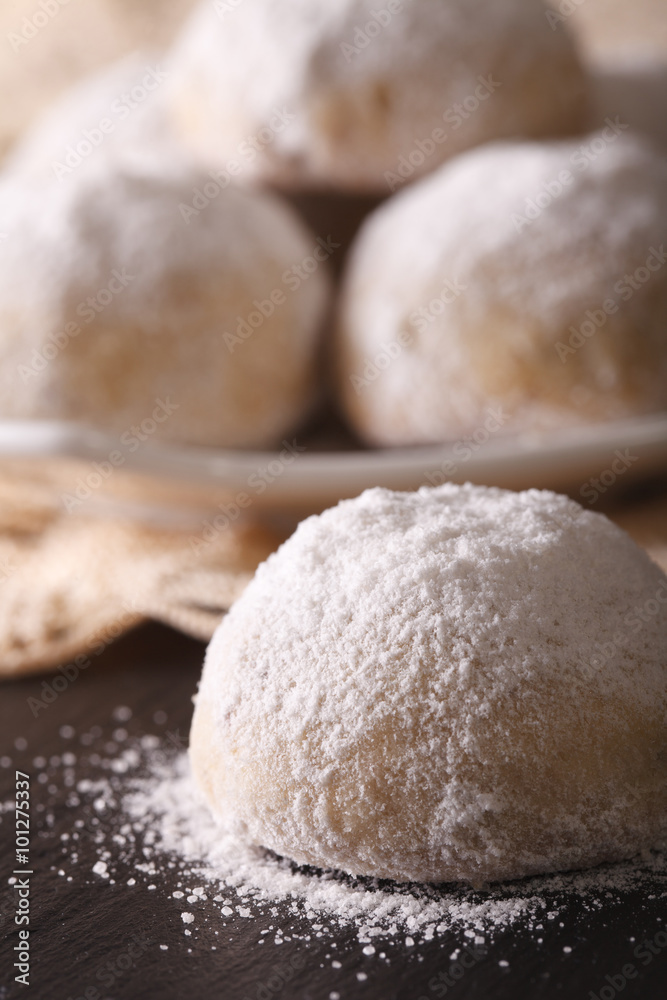 Mexican wedding cookies on the table close-up. vertical
Mexican wedding cookies on the table close-up. vertical