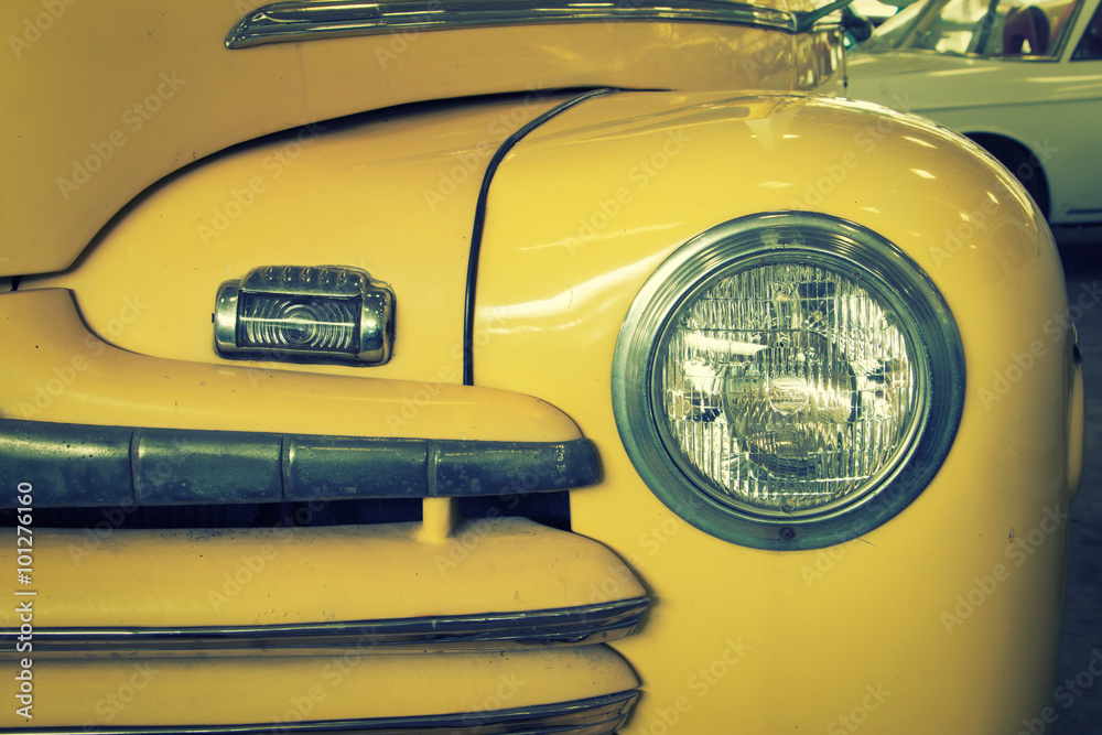 Close Up of Front of a Yellow Vintage Car