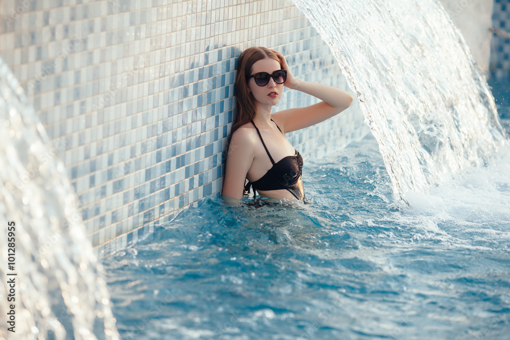Portrait of a beautiful woman in a swimming pool. beautiful long