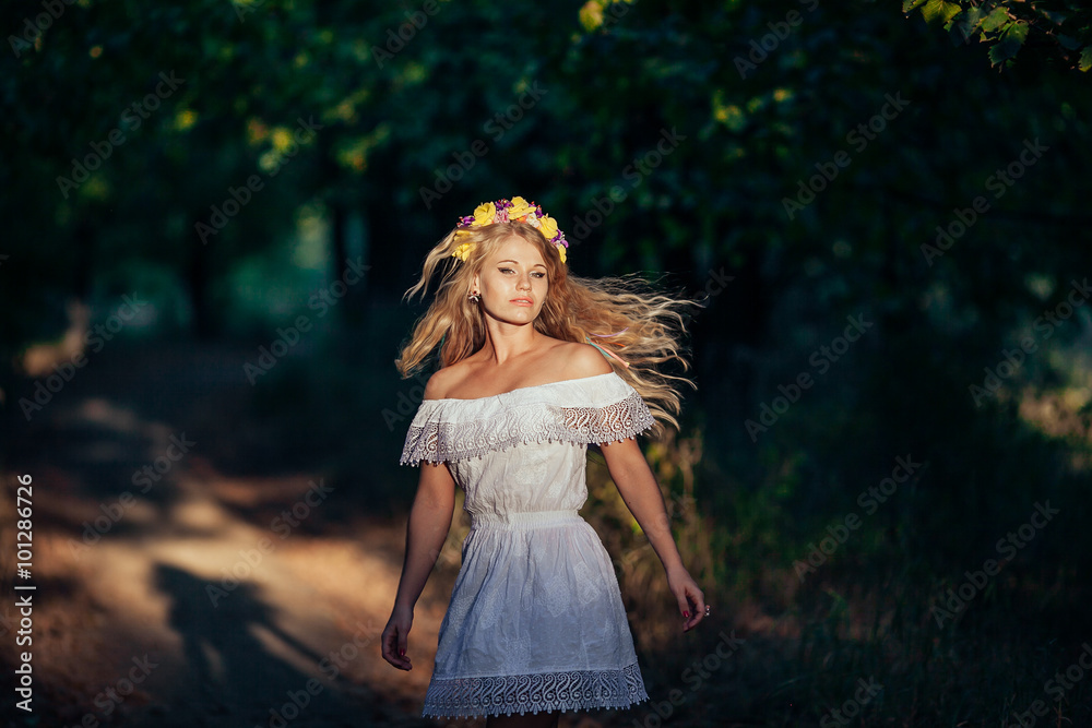 Portrait of blonde girl wearing white dress with flower wreath Portrait of blonde girl wearing white dress with flower wreath