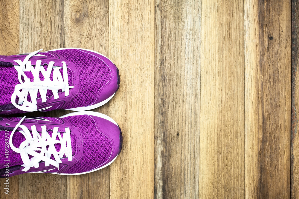 Fototapeta premium Purple Sneakers with wooden background