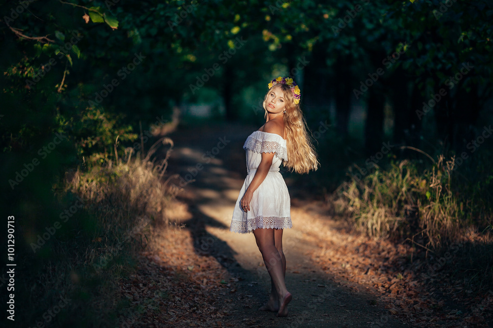 Portrait of blonde girl wearing white dress with flower wreath Portrait of blonde girl wearing white dress with flower wreath