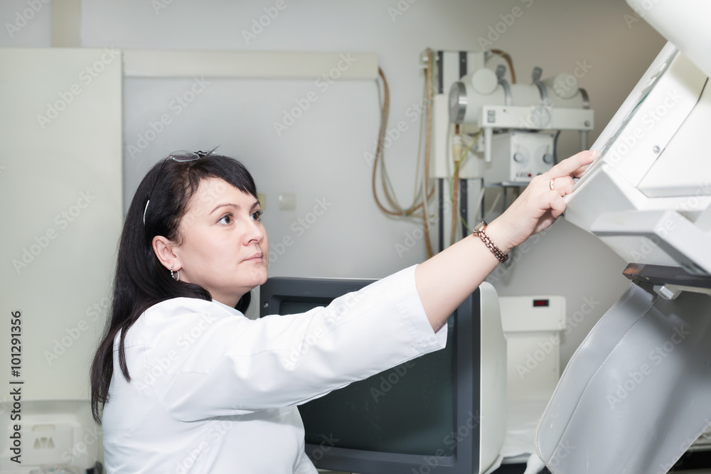 Brunette female doctor working with x-ray machine