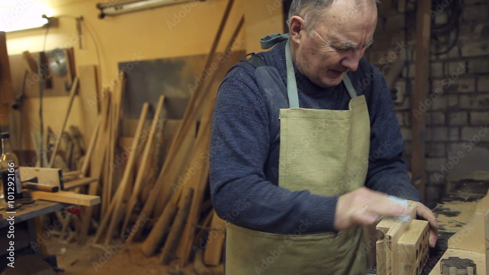 man sandpaper grinds wood man sandpaper grinds wood