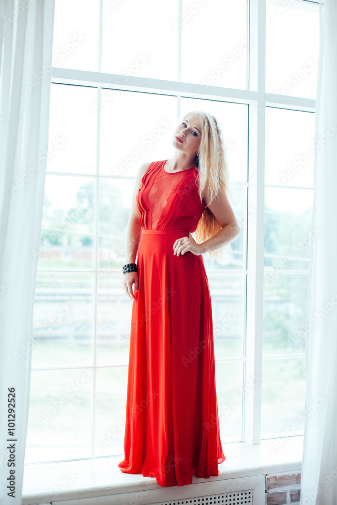 full-length portrait of young beautiful blonde woman with red li full-length portrait of young beautiful blonde woman with red li