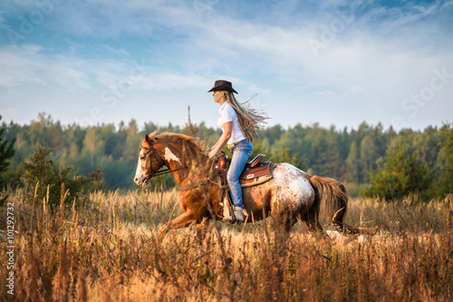 Girl riding on the Appaloosa horse