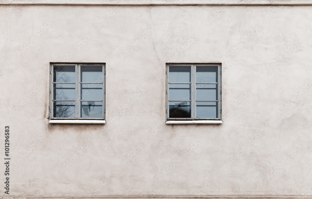Two windows in modern gray concrete wall
