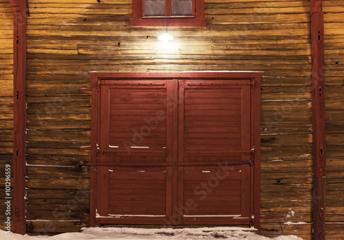 Fototapeta Naklejka Na Ścianę i Meble -  Old wooden gate of warehouse with spotlight