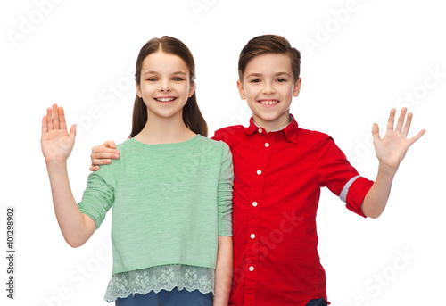 happy boy and girl waving hand