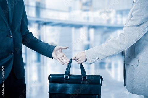 business transfer. handover of a suitcase partners