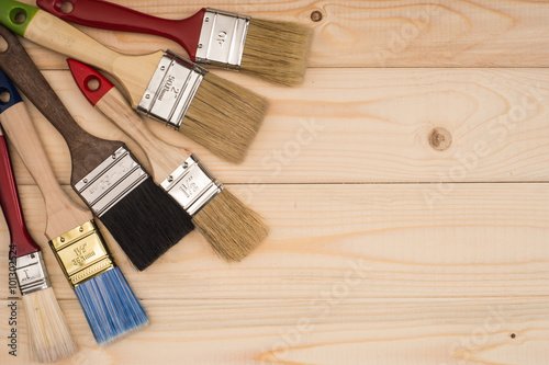 Fototapeta Naklejka Na Ścianę i Meble -  paint brush on wooden background