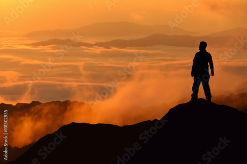 Silhouette of man standing on the top of mountain © chanwitohm