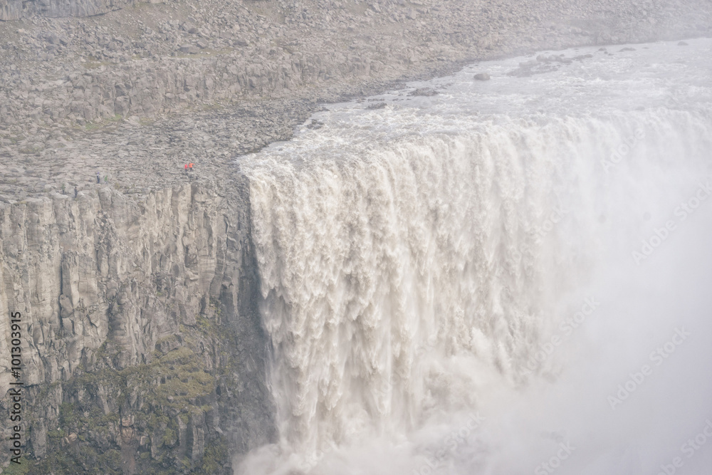 Fototapeta premium Dramatic view of famous Dettifoss waterfall with two small people, Iceland.