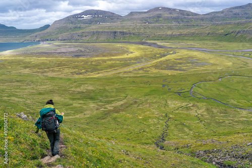 Woman hiking in most the isolated icelandic national park - Hornstrandir. photo