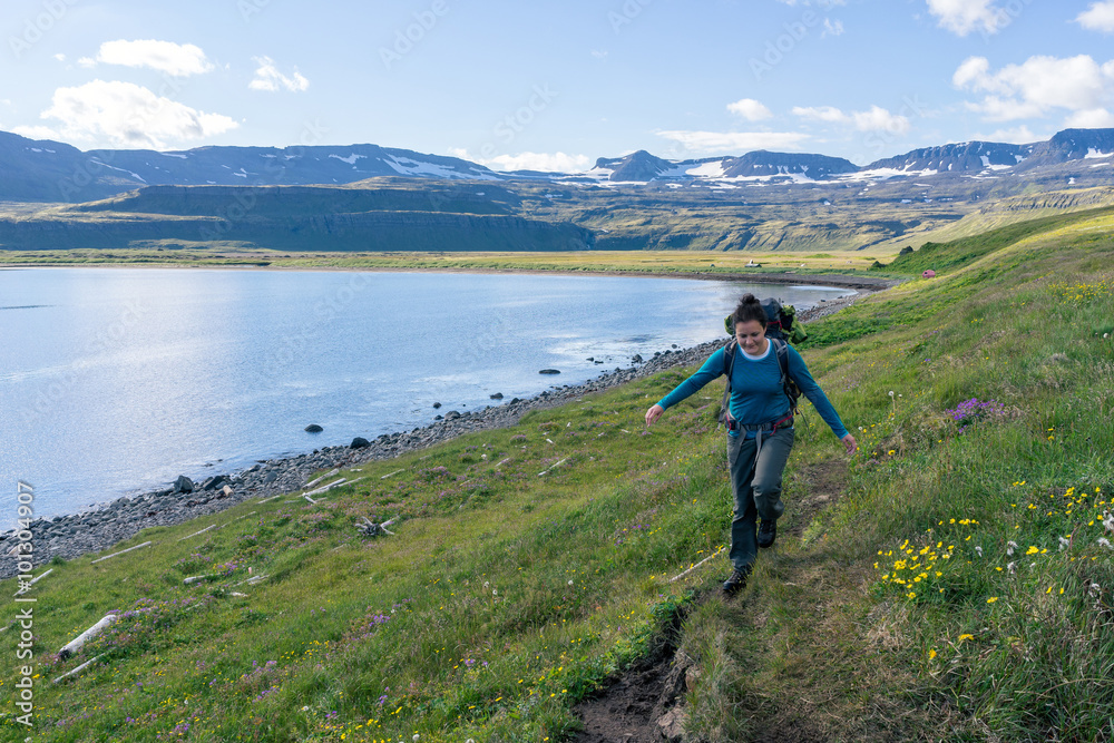 Woman hiking in most the isolated icelandic national park - Hornstrandir.