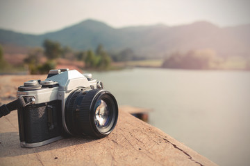 Vintage camera with view of lake and mountain