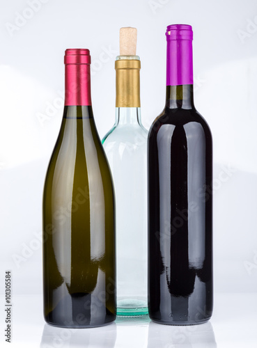 Three wine bottles isolated on white background